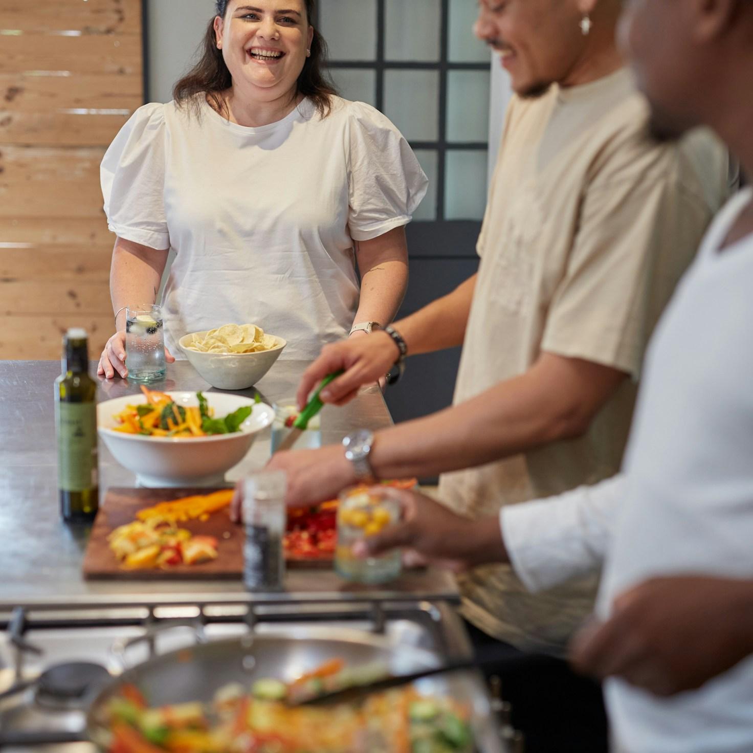 Community members collaborating in a modern kitchen space, sharing recipes and cooking techniques
